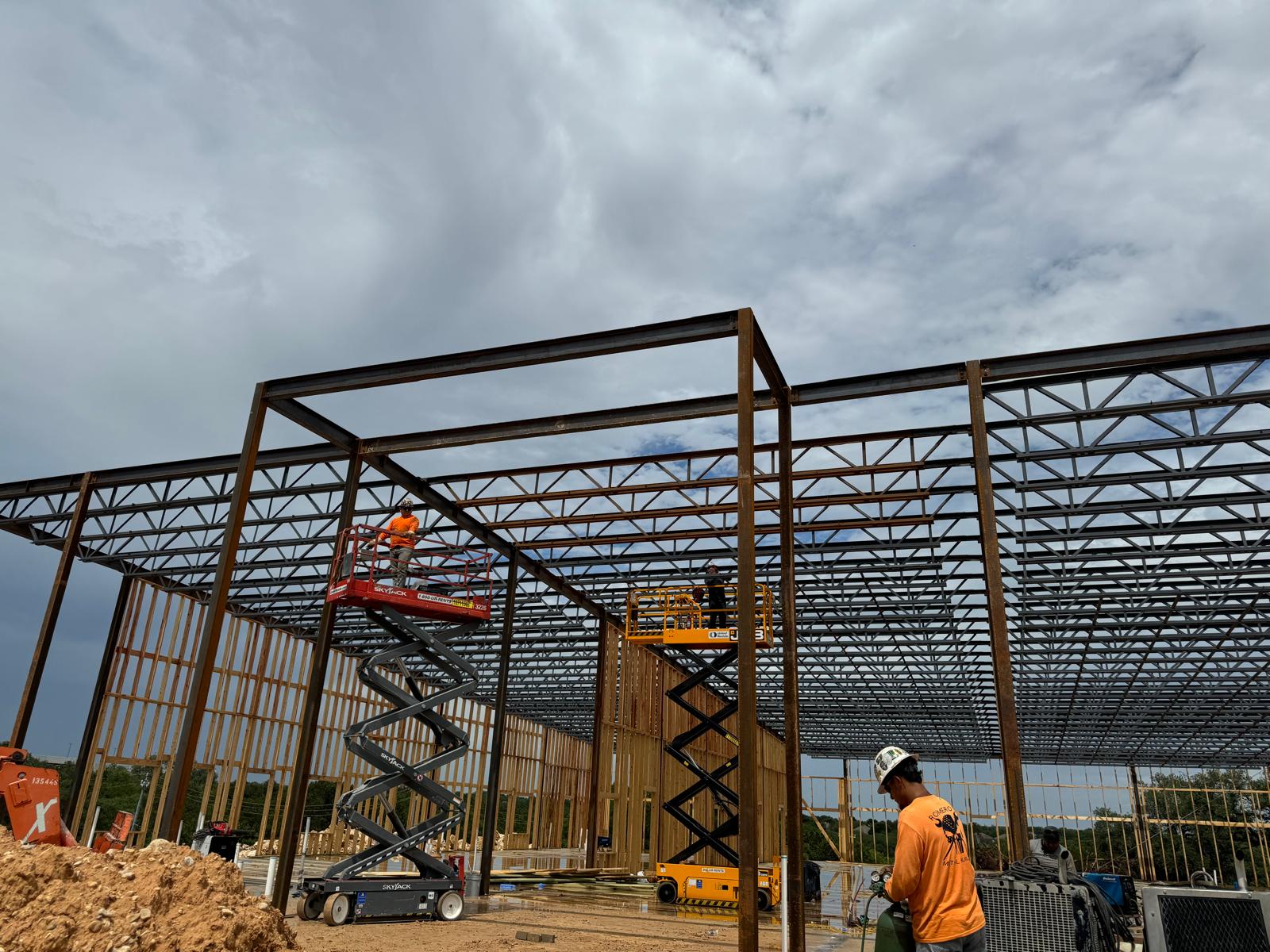 Crane lifting a steel beam into place